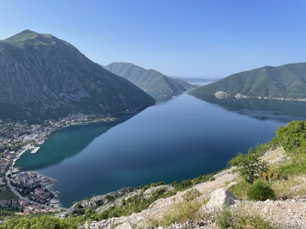 a body of water with mountains in the background