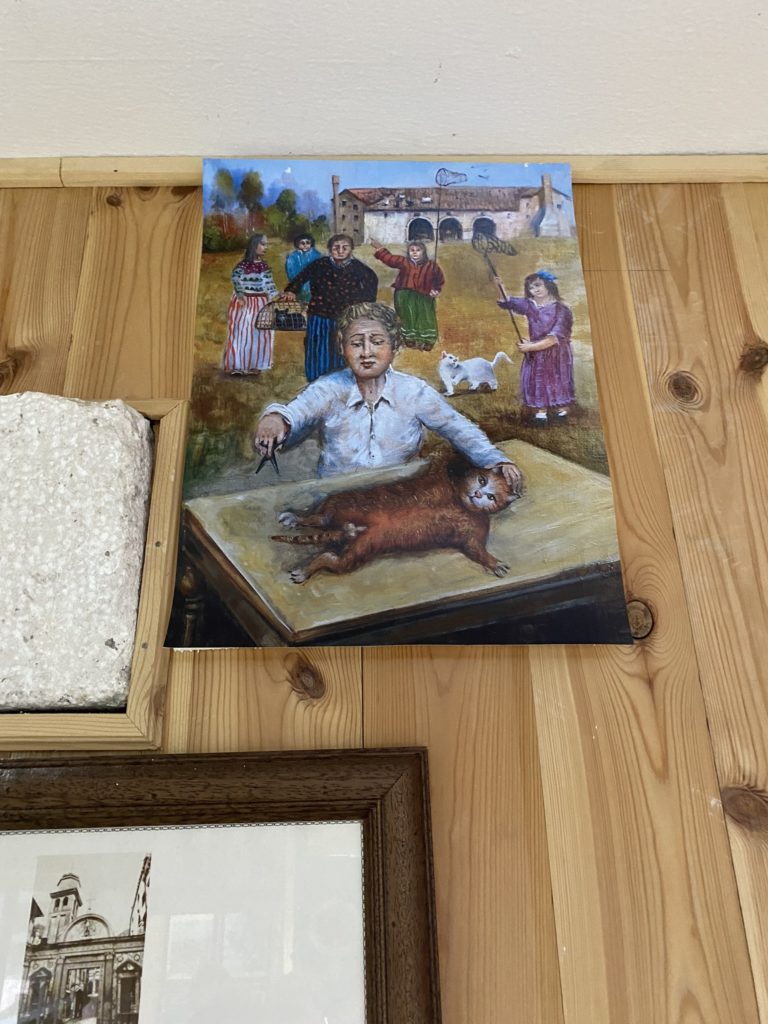 a painting of a boy and a cat on a table