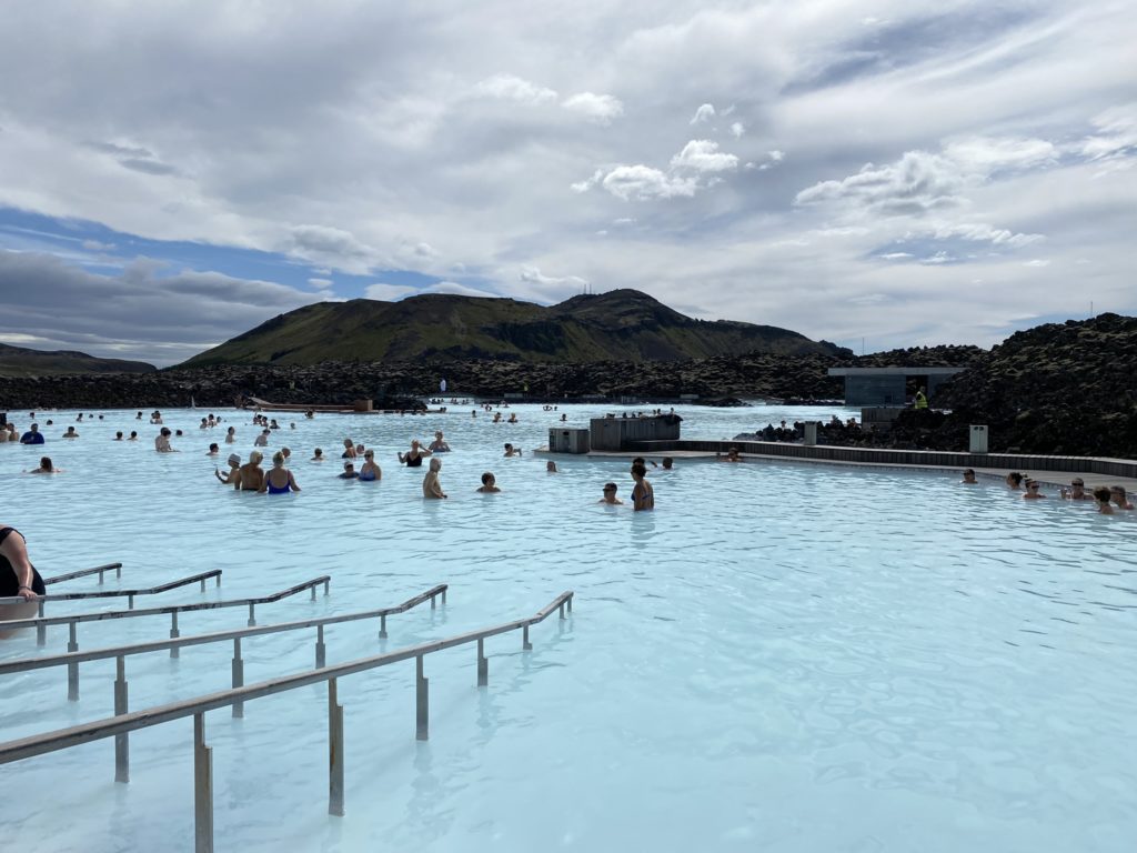 a group of people in a pool with Blue Lagoon in the background