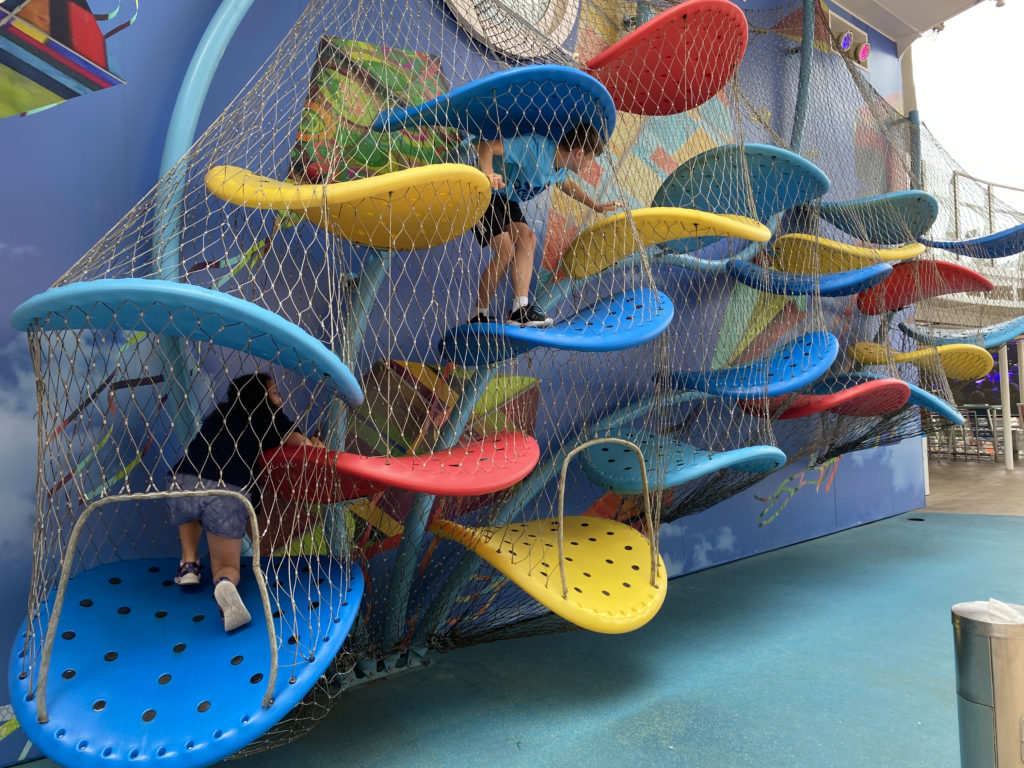 a group of kids climbing on a playground