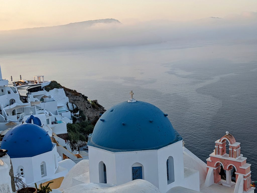a blue and white buildings with a body of water in the background