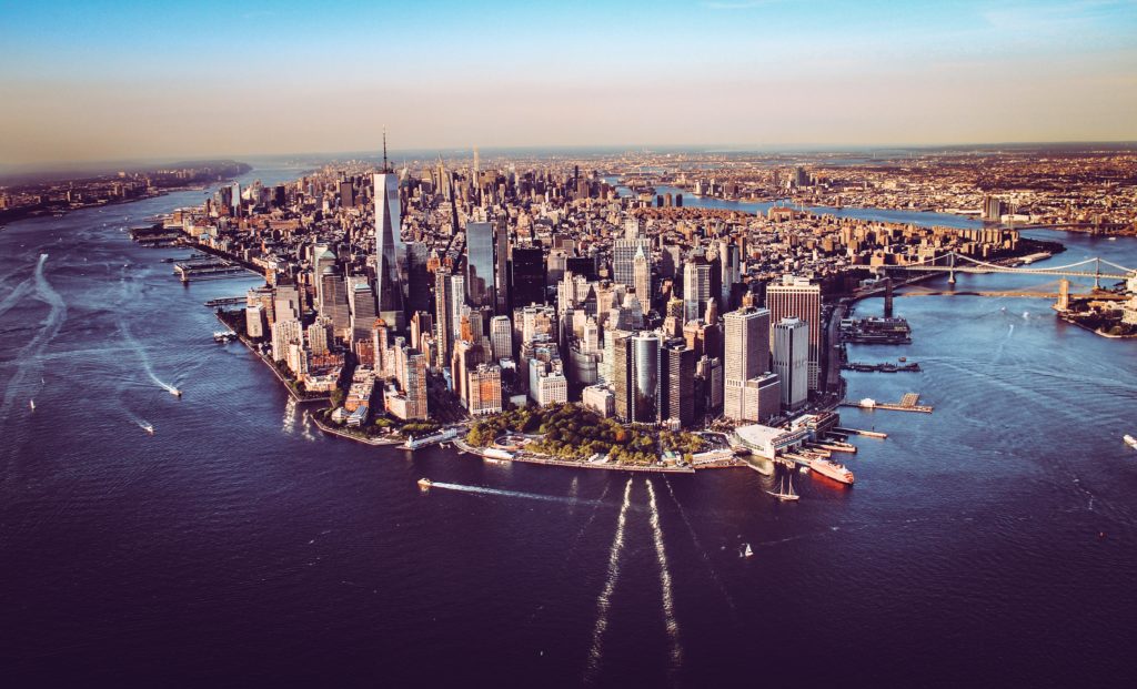 a city with many tall buildings and a body of water
