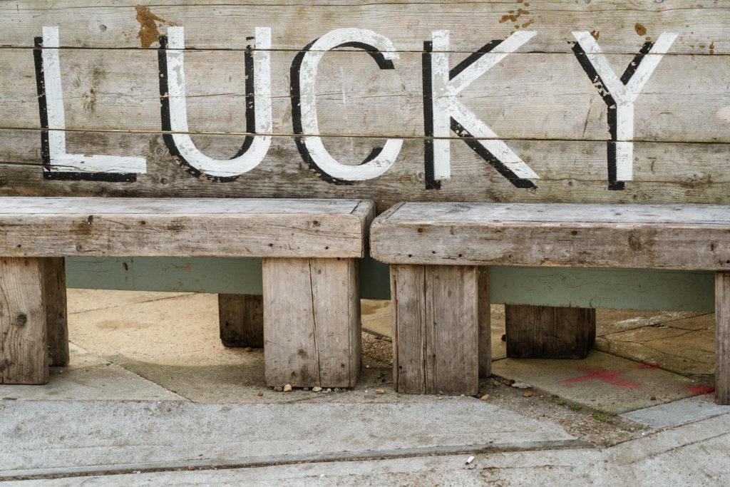 a wooden bench with a sign on it