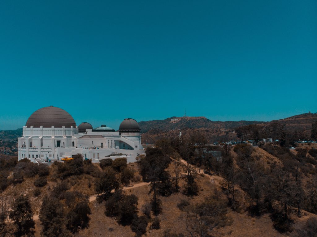 a white building with black domes on a hill