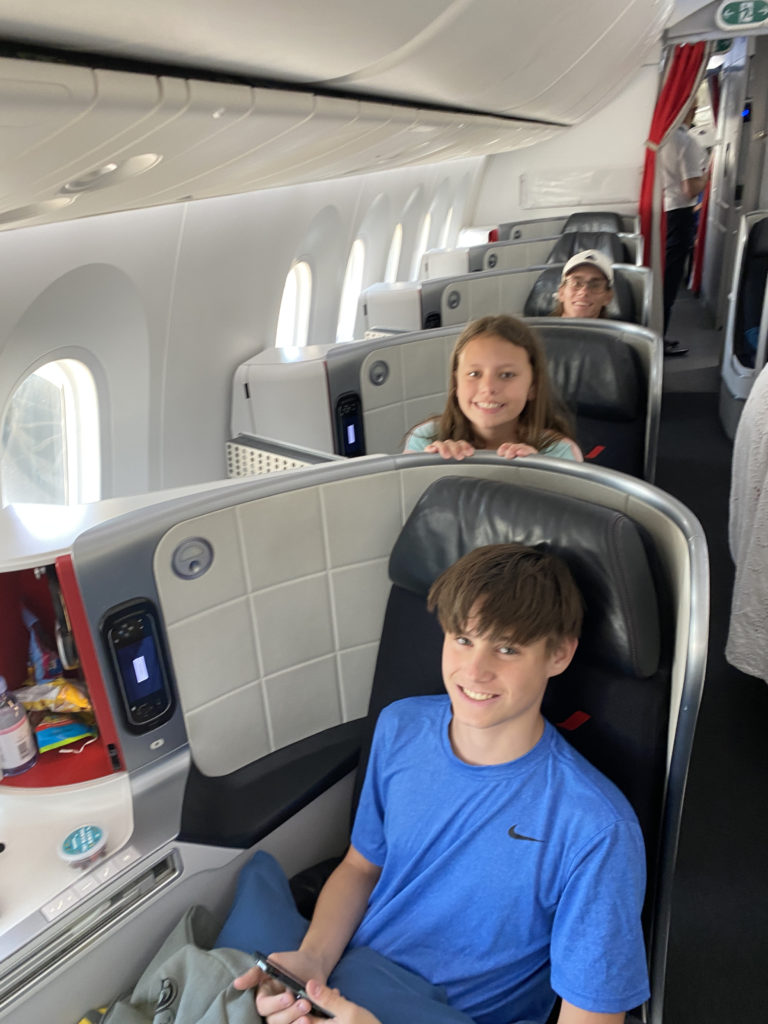 a group of kids sitting in a plane