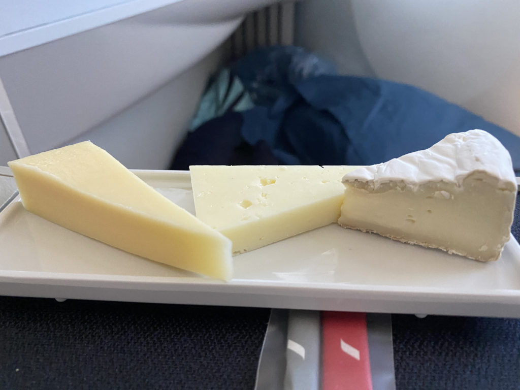 a plate of cheese on a plane