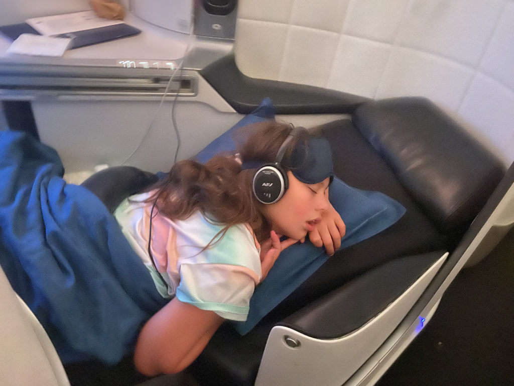 a girl sleeping on a bed