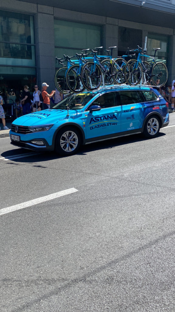 a blue car with bicycles on top