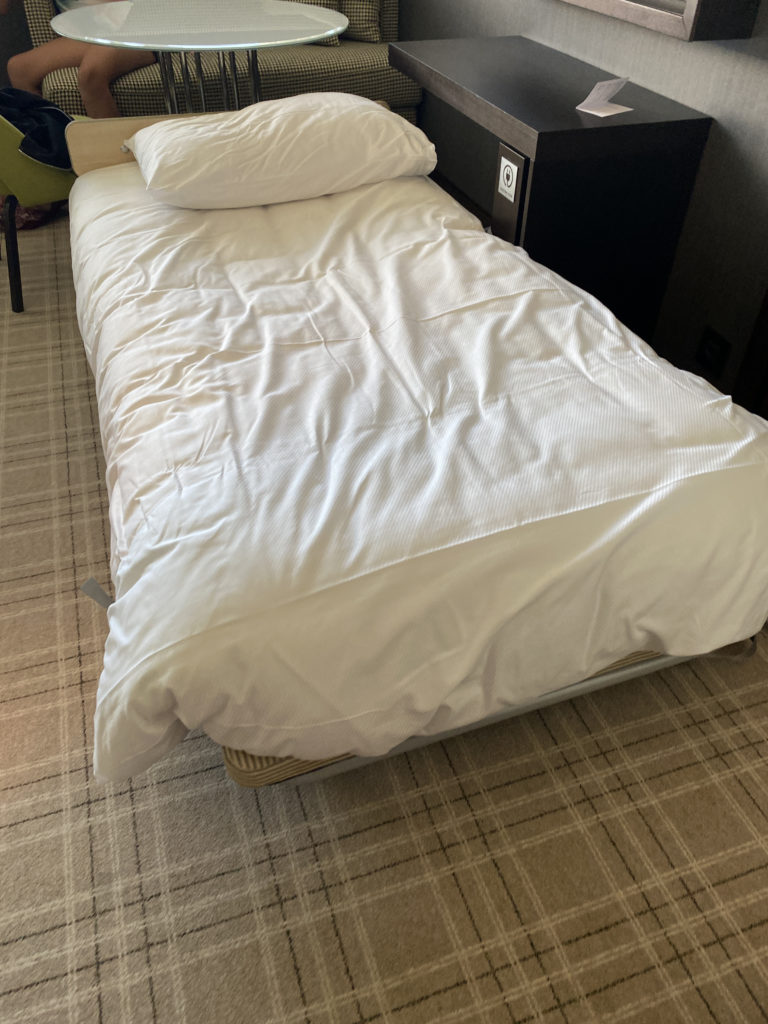 a bed with a white sheet and pillow