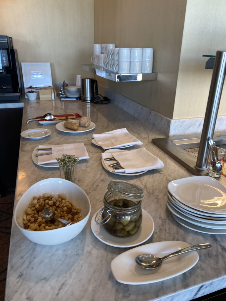 a kitchen counter with plates and bowls of food