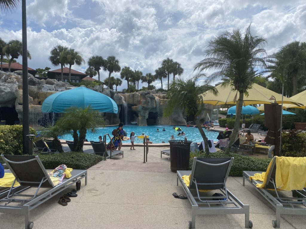 a pool with lounge chairs and umbrellas