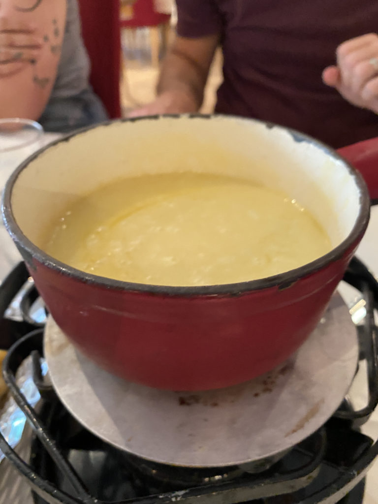 a red bowl with yellow liquid inside