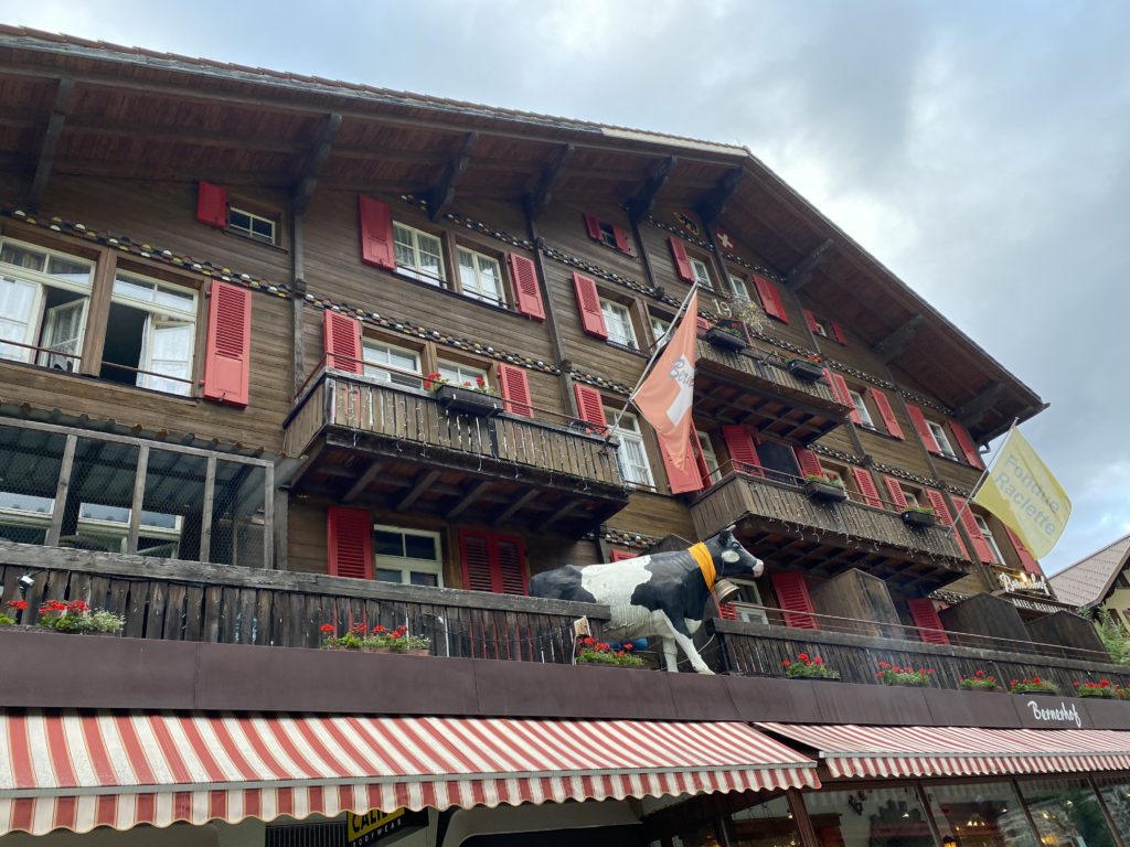 a building with a cow statue on a balcony