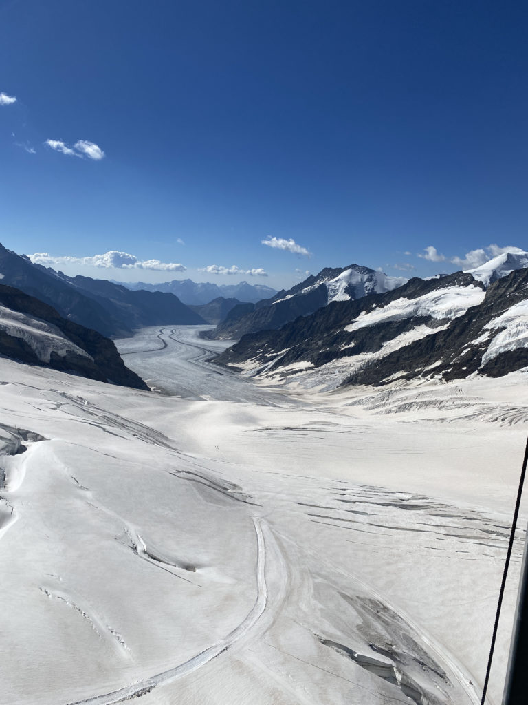 a snowy landscape with mountains and blue sky