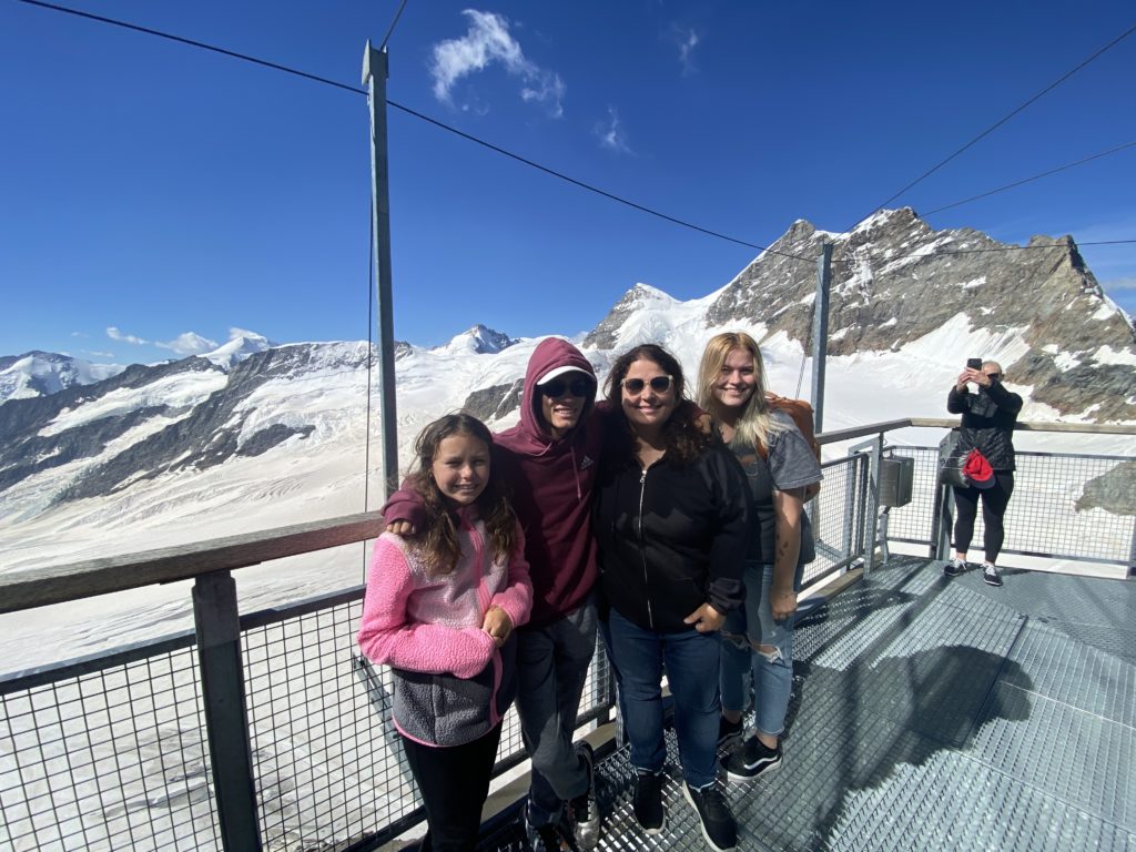 a group of people posing for a picture on a metal platform