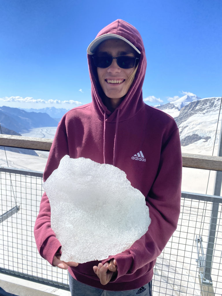 a person holding a large piece of ice