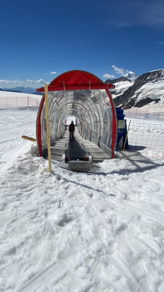 a person walking in a tunnel on snow