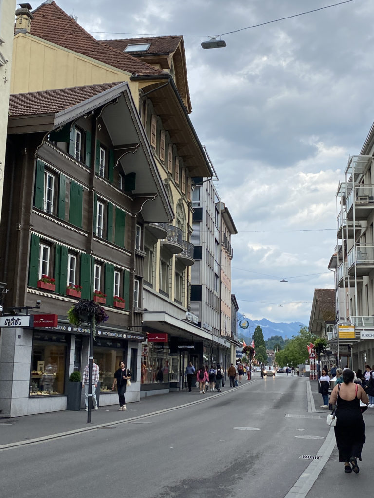 a street with buildings and people walking on it