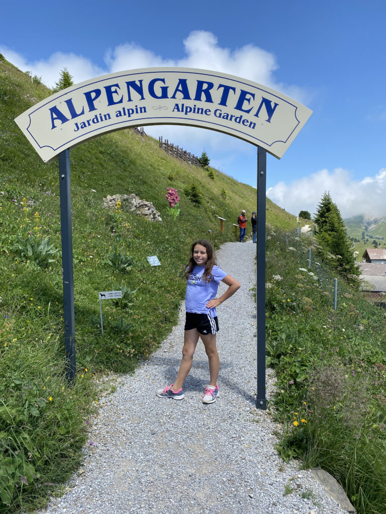 a girl standing in front of a sign