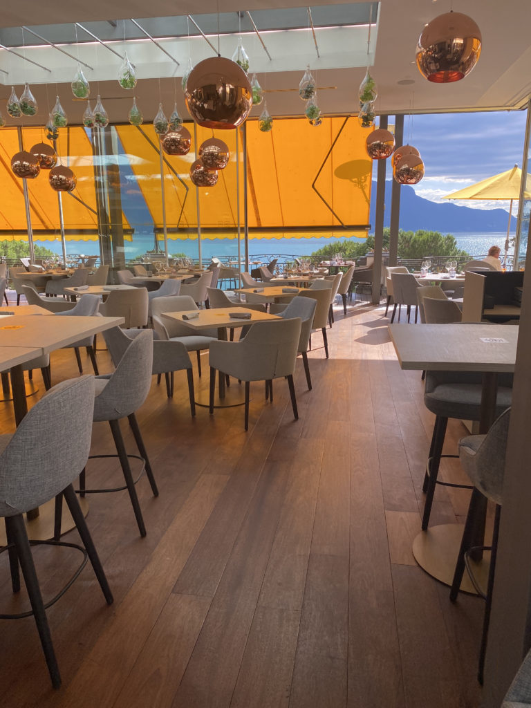 a room with tables and chairs and a yellow awning