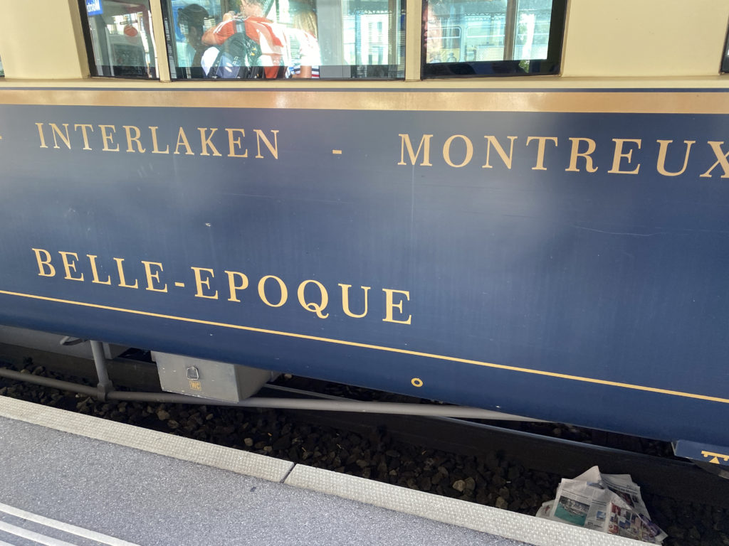a blue train with gold text on it