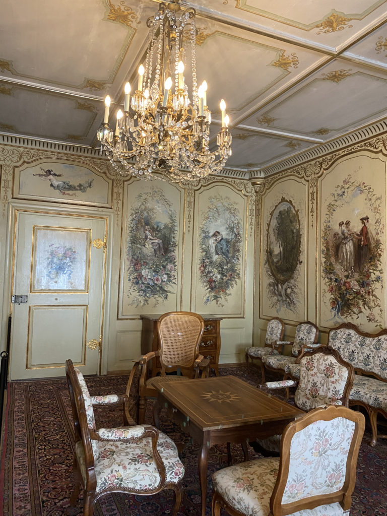 a room with a chandelier and chairs