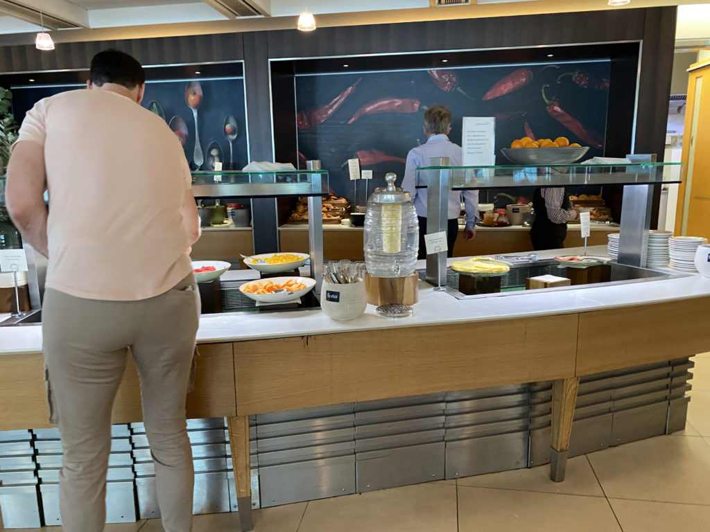 a group of people standing in front of a buffet