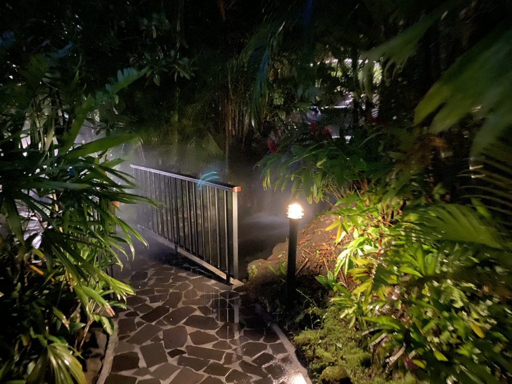 a walkway with a metal railing and a light on it