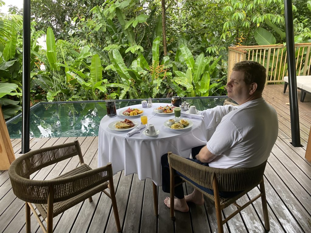 a man sitting at a table with food on it