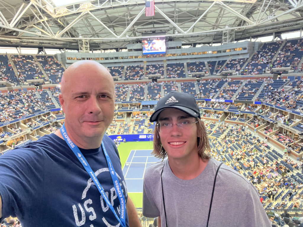 two men taking a selfie in a stadium
