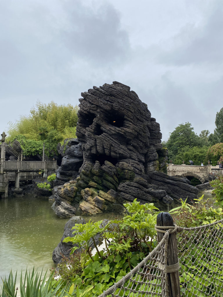 a rock structure with a skull face
