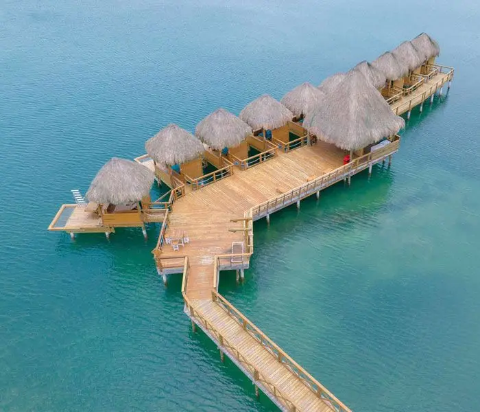a dock with straw huts on it