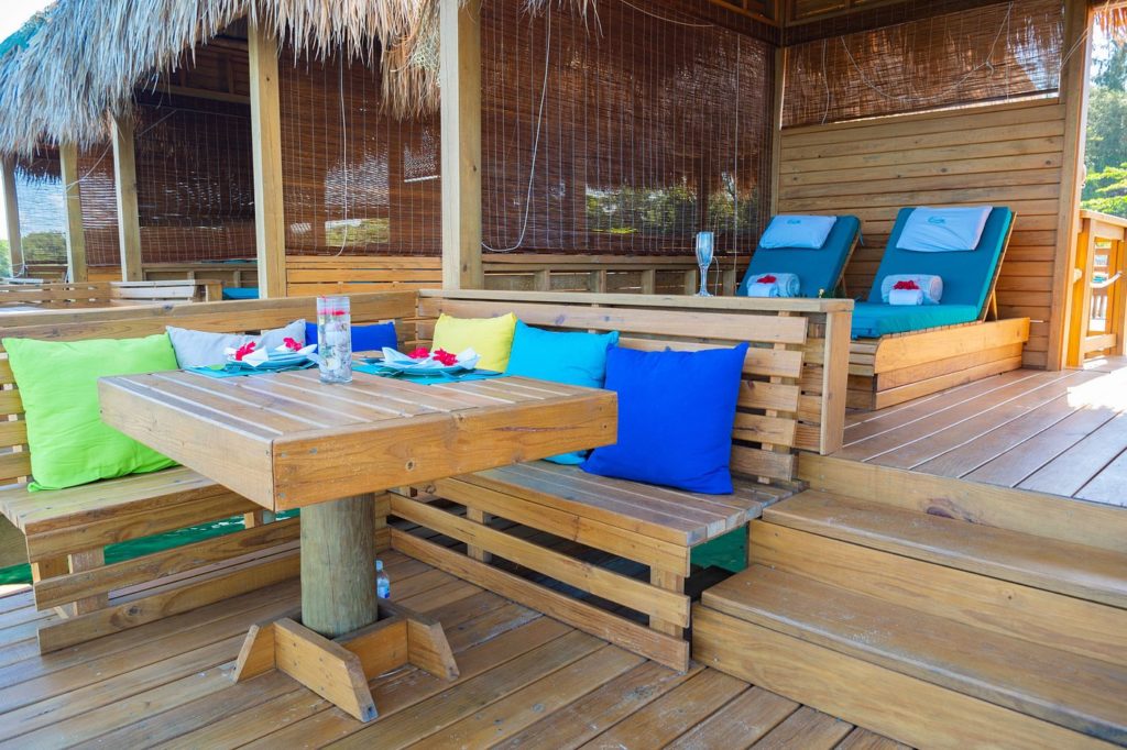 a wooden deck with chairs and a table