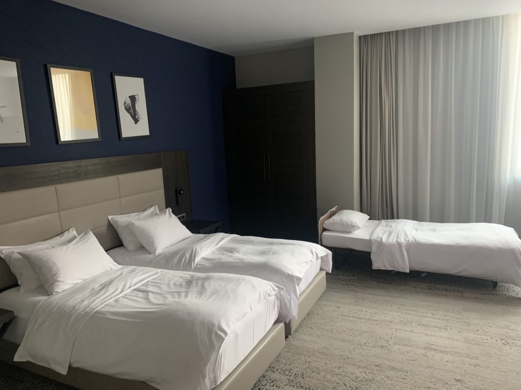 a room with two beds and a window