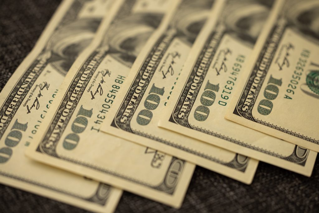 a stack of money on a surface