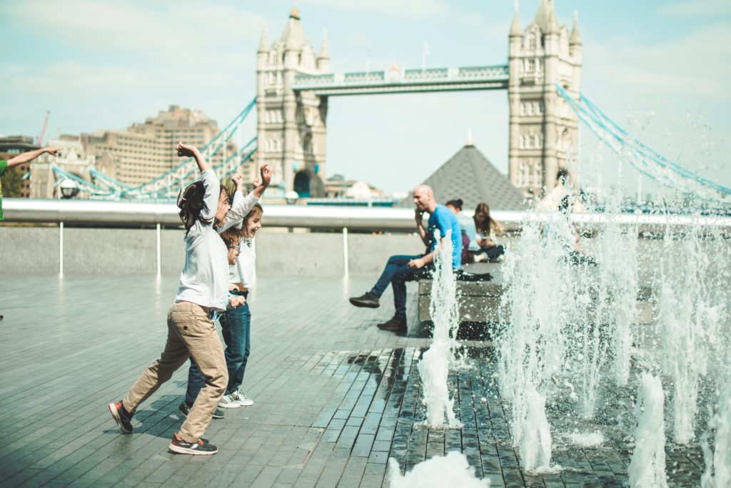 a group of people playing in a fountain