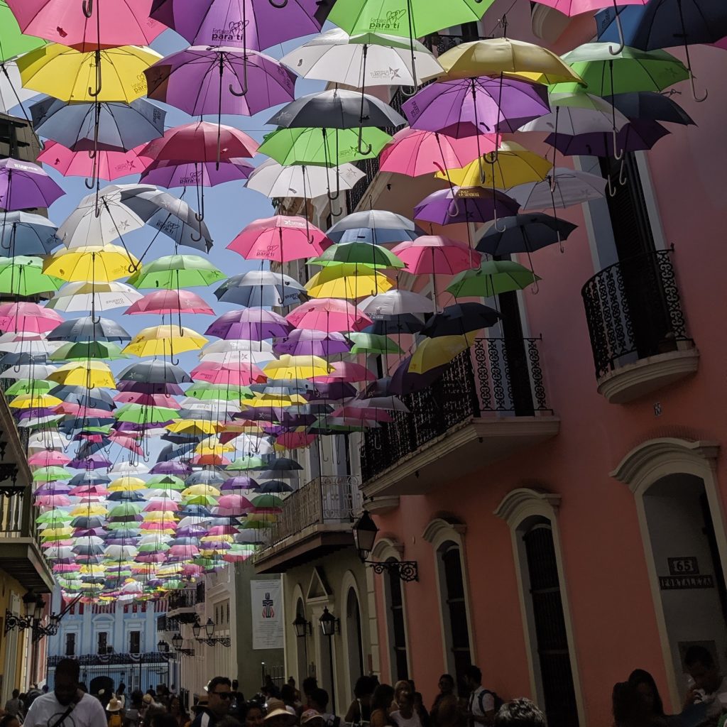 a group of people walking down a street with umbrellas