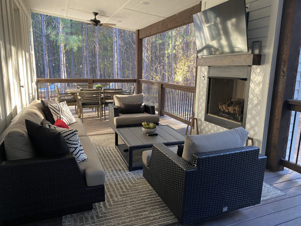 a patio with a fireplace and furniture