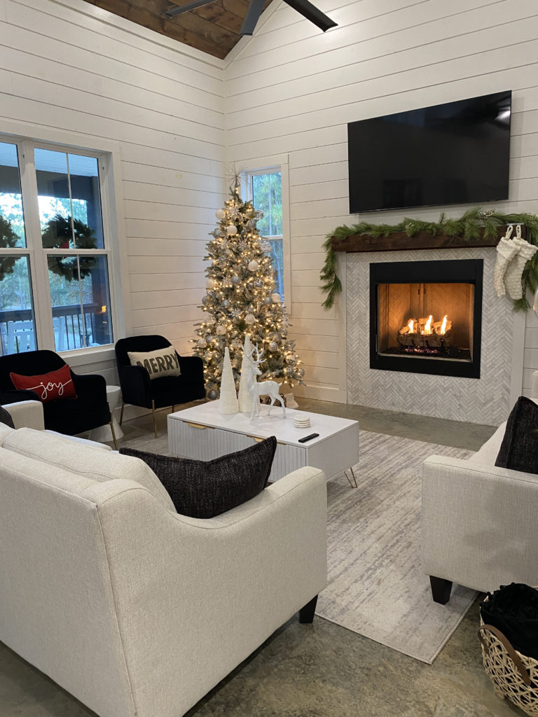 a living room with a christmas tree and fireplace