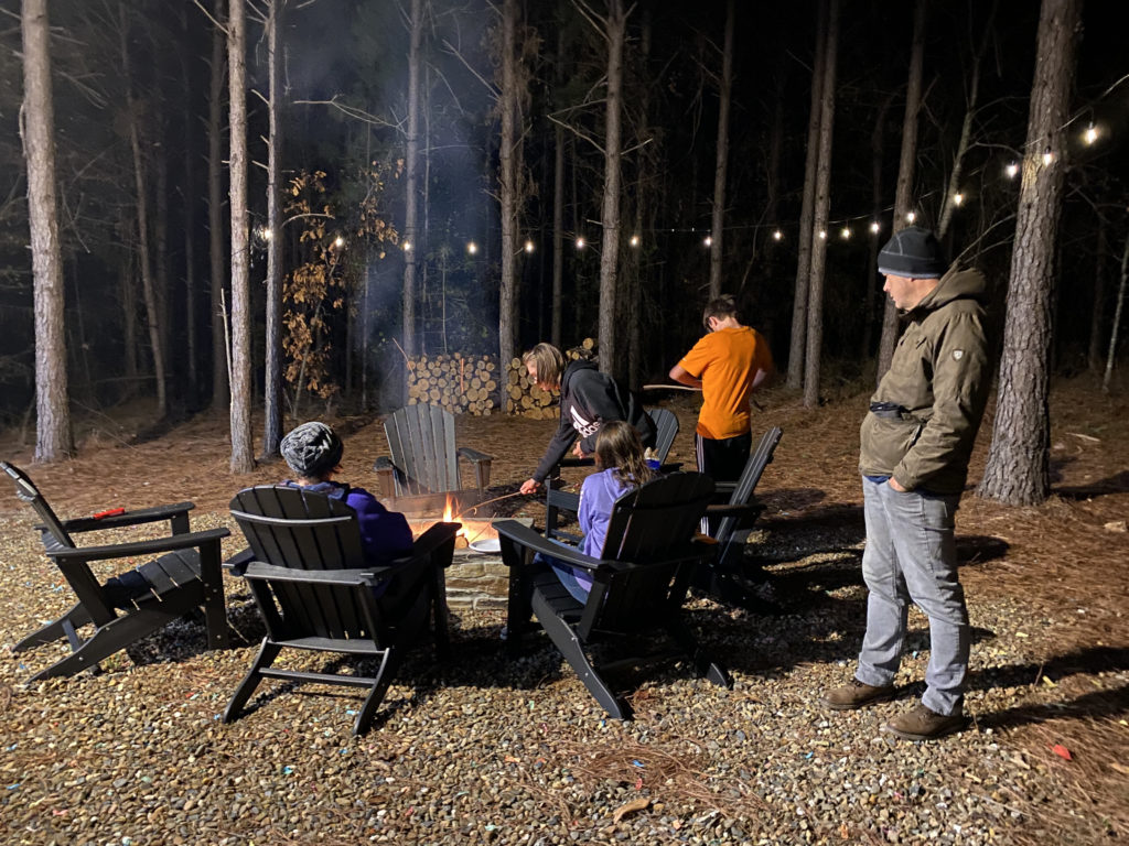 a group of people around a fire pit