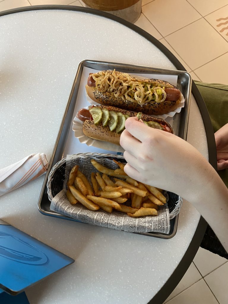 a person eating a hot dog and fries