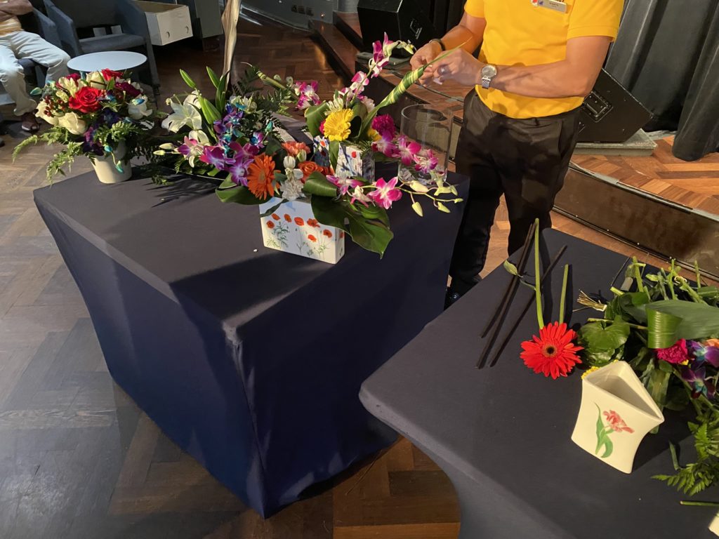 a man arranging flowers on a table