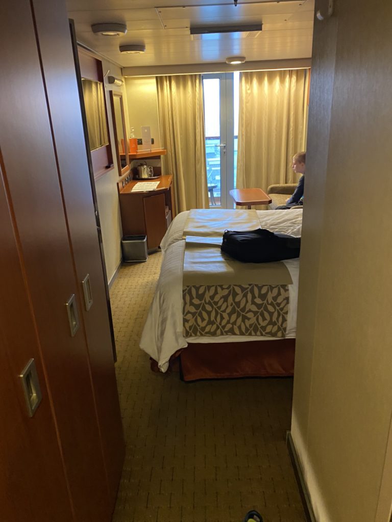 a room with a bed and a backpack