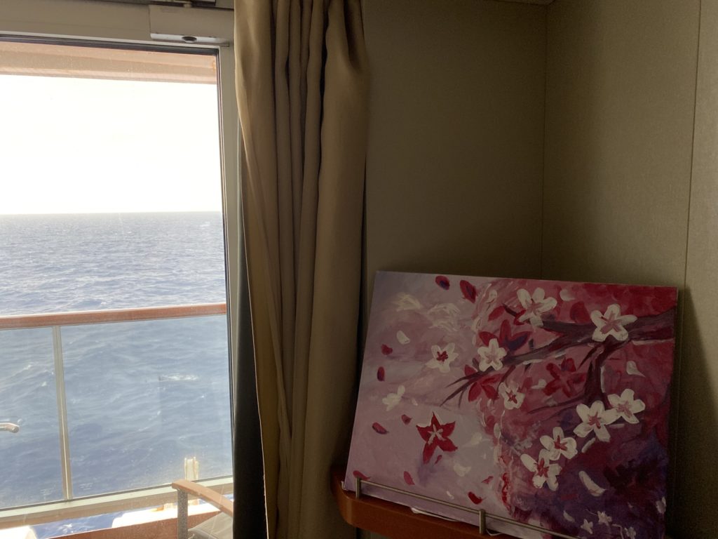 a painting on a shelf next to a window