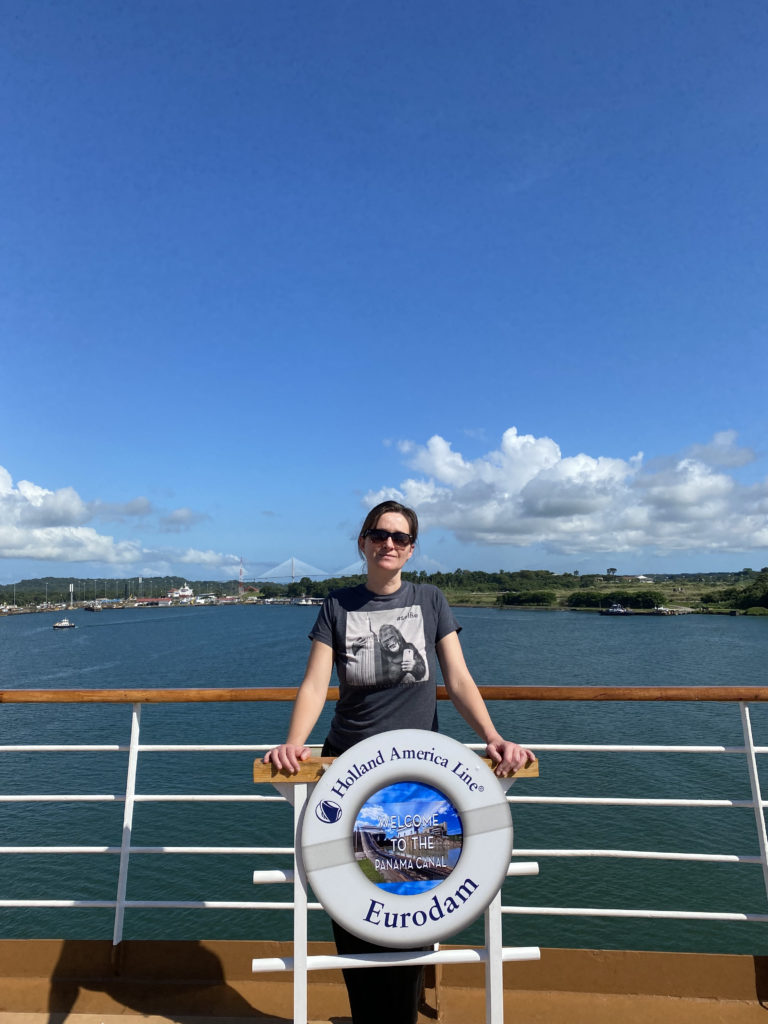 a woman standing on a railing with a life preserver on the railing