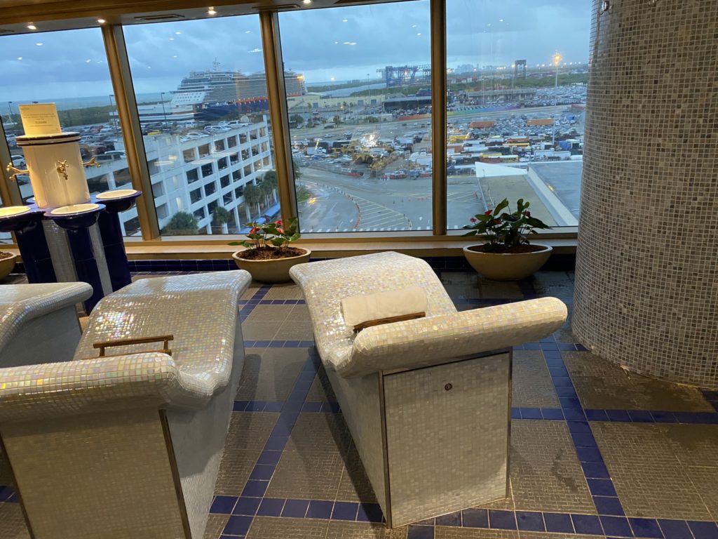 a room with a large window and chairs
