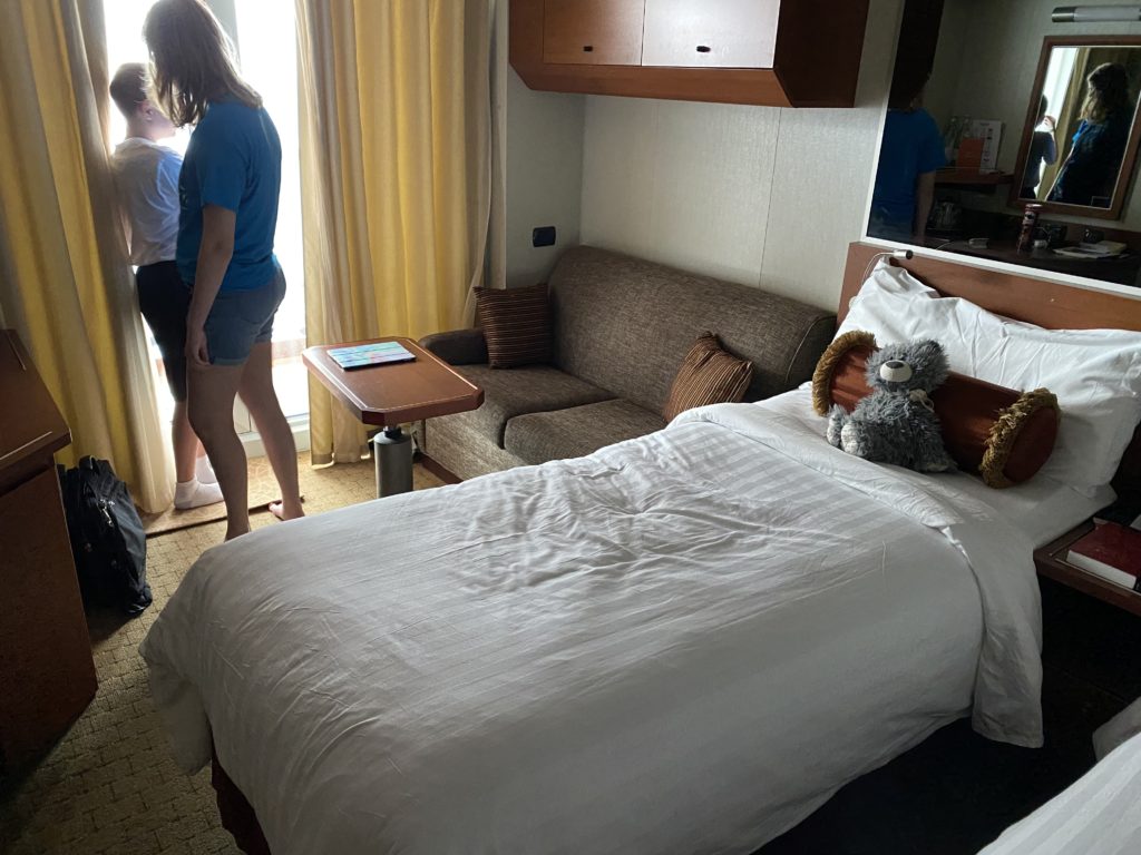 a couple of women standing in a hotel room
