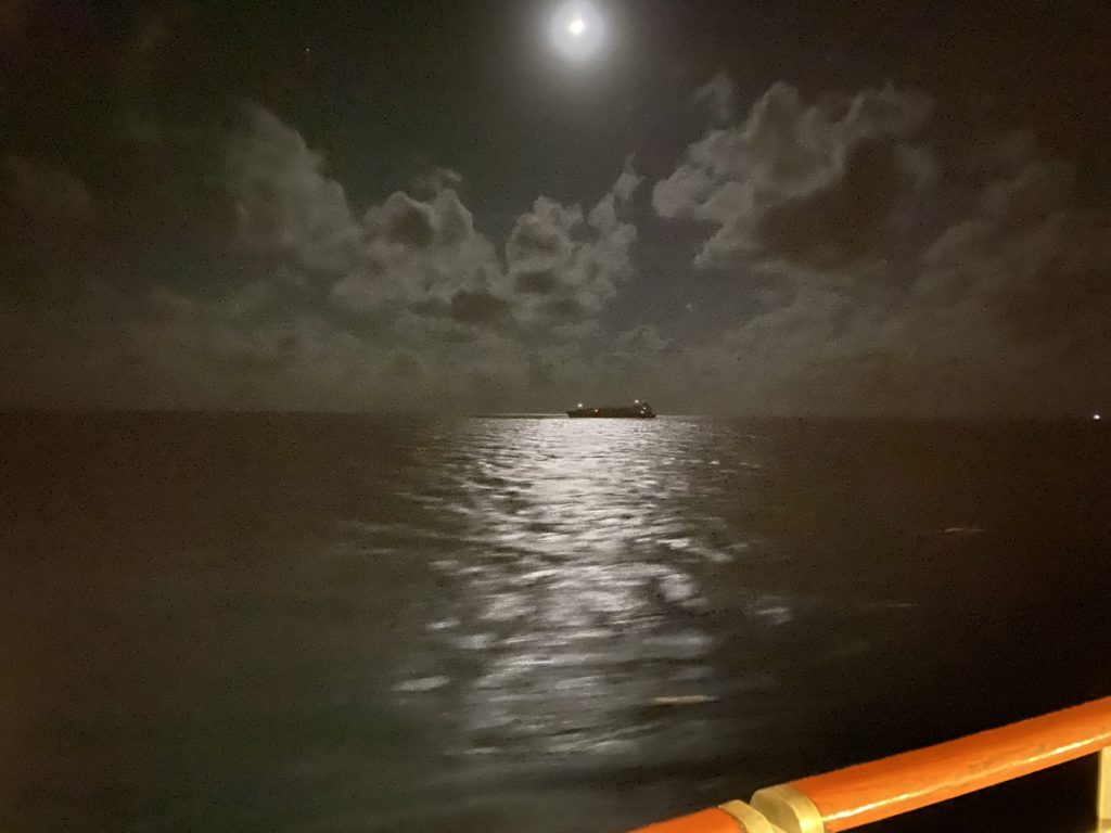 a boat on the water at night