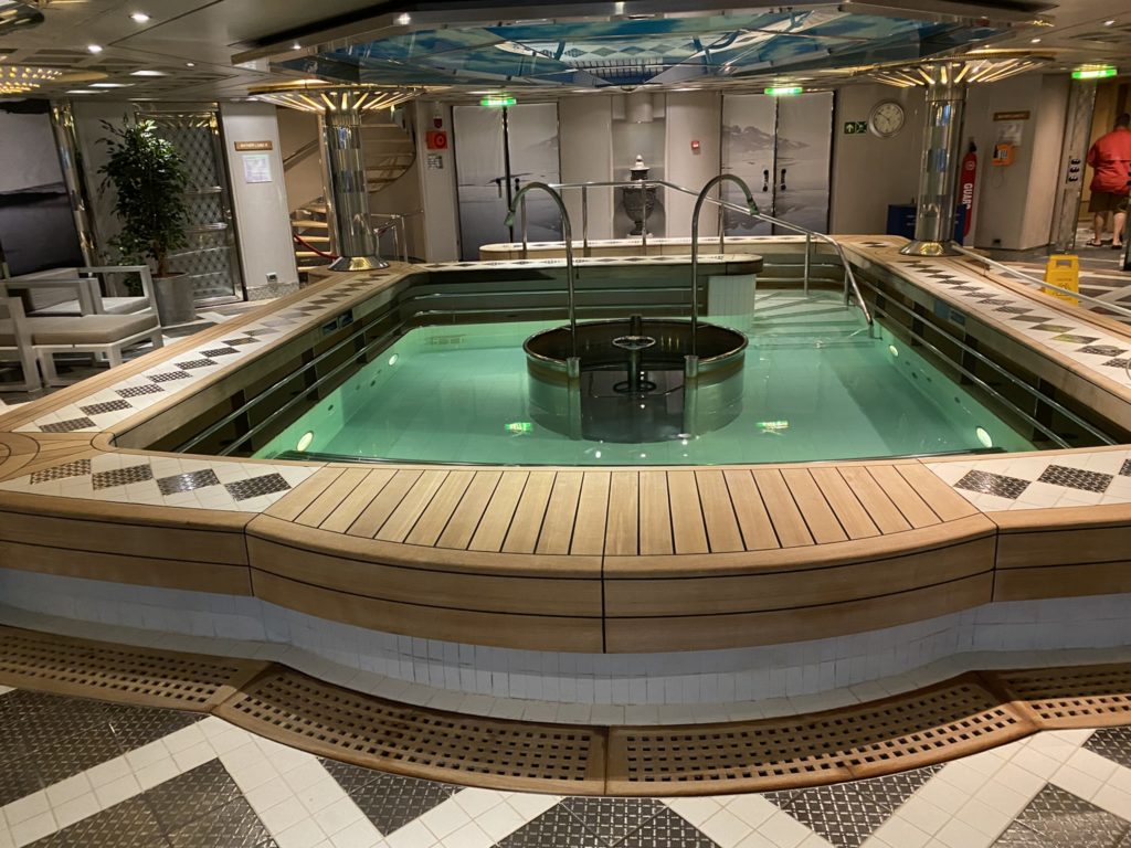 a large indoor pool with a wooden deck