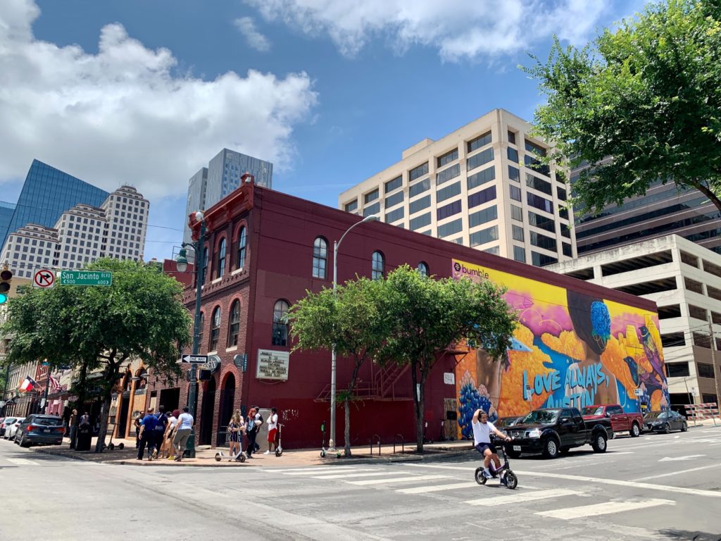a street with a mural on the side of it